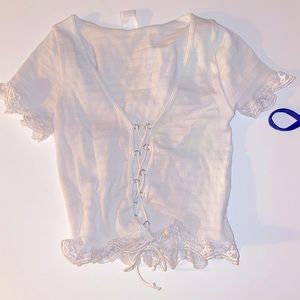 White top with crisscrossing string in the front